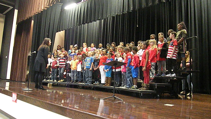 Students perform on the stage for Veterans Day.