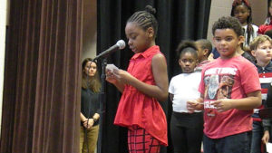 A student practices her poem for the concert.