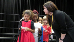 A student practices her poem for the concert.