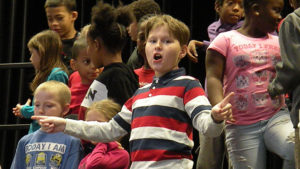 A third grade student practices the words to one of their songs.