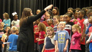 Miss Komsa gives the students final instructions prior to the concert.