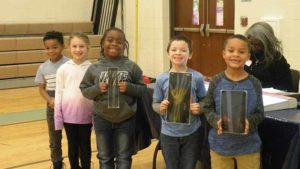 Students show off the x-rays that they had a chance to use for an experiment.