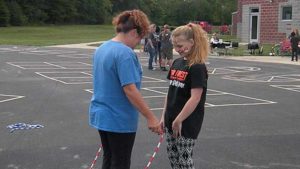 A mother and daughter have fun with their jump rope.