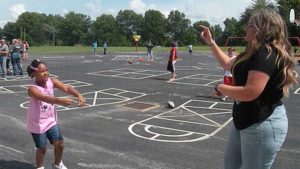 A student and teacher show off their dance skills.