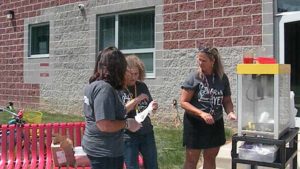 Fourth grade teachers making popcorn for the carnival.