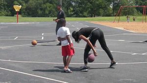 Family members having fun playing basketball together.