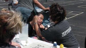 A student gets her face painted.