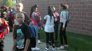 Girls wait and visit before the school day begins.