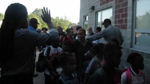 Students and families coming in for their first day to cheers and high-fives.