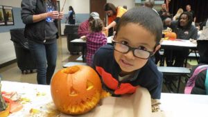 A student shows off his finished pumpkin.