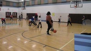 Students from Harding play games in the gym with our 3rd grade students.