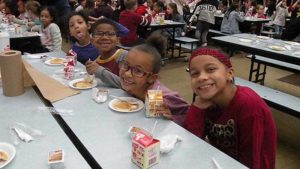 Third grade students having fun during their pancake breakfast.