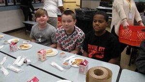 Three fifth grade students take a picture during our pancake time.