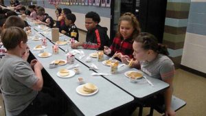 Fifth grade students enjoying their pancakes and time together.