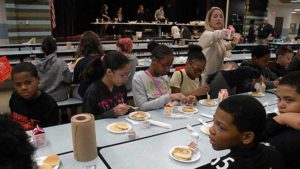 Fifth graders enjoying their pancakes.