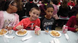 Students enjoying their pancakes.