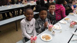 Second graders enjoying their pancakes.
