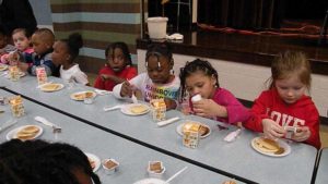 Kindergarten enjoying their pancakes.
