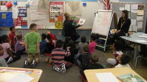 Students listening to a book with their guest reader.