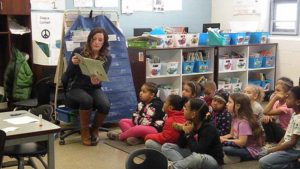 One of our guests shares a book with the class.