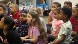 Students listen as their guest reader shares a story.