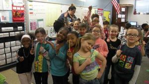 Students show off the pencils that they got from their guest.