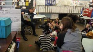 A guest reader shows the pages of the book he is sharing.