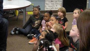Kindergarten listens to a story.