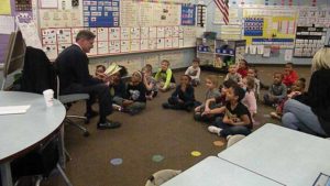 Kindergarten listens to a story.