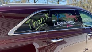The side window of a car that is decorated to say "Thank you families, I appreciate you".