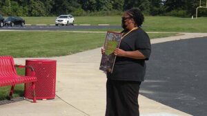 Ms. Betts shows the book they will be using for their lesson.