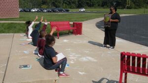 Students raise their hands to answer a question.