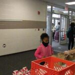 A student receives her breakfast before going to class.