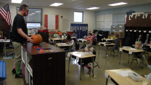 Students in Mr. Bitner's class listen to directions about their activity