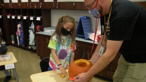 A student outs her seeds onto a napkin for counting