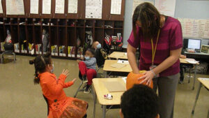 Mrs. Haswell scoops out seeds for each student