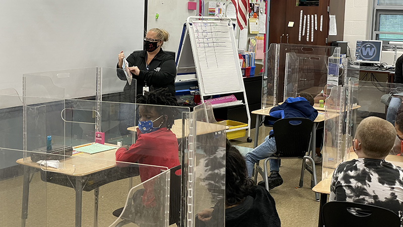 A volunteer reads to Mrs. Hammond's class.