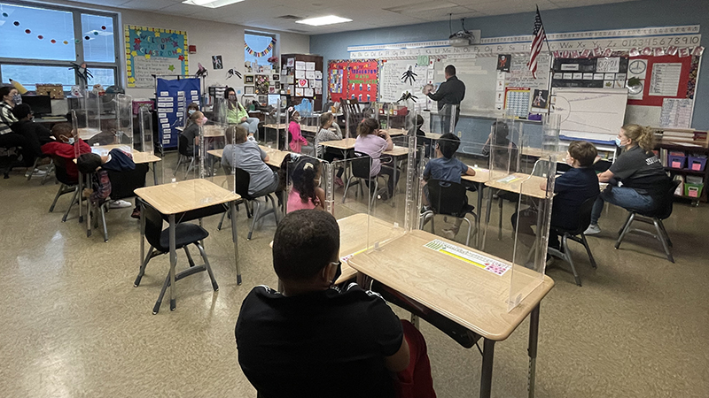 Mrs. Laprocina's class listens as their volunteer reads.