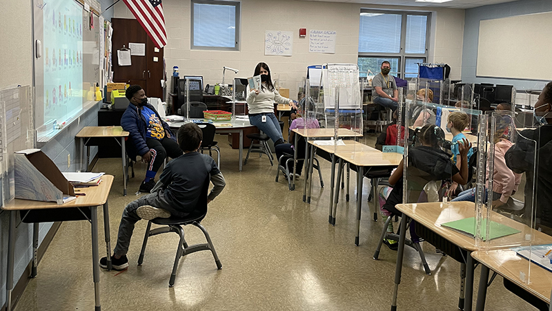 Mr. Irwin's class listens to a story.