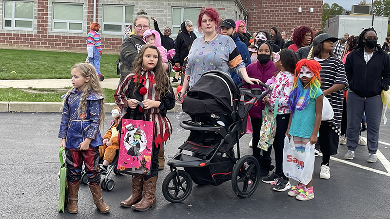 A family waits for their turn to begin trunk or treat.