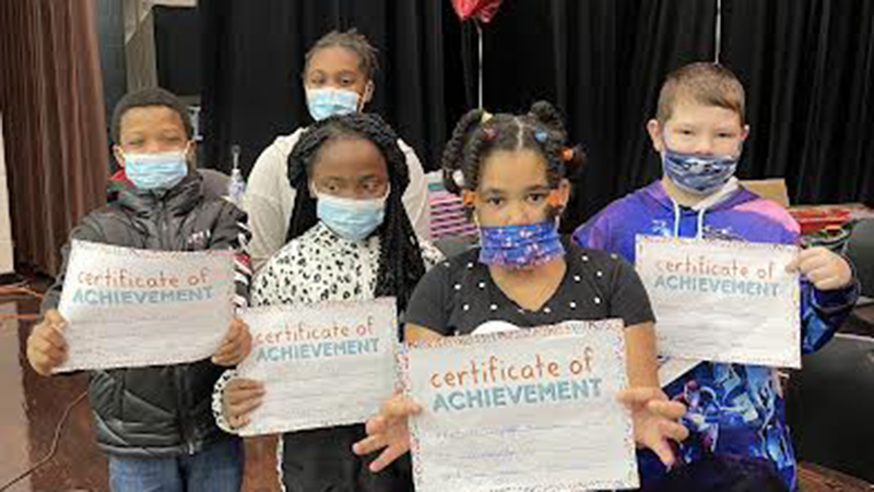 5 students holding geography bee certificates.