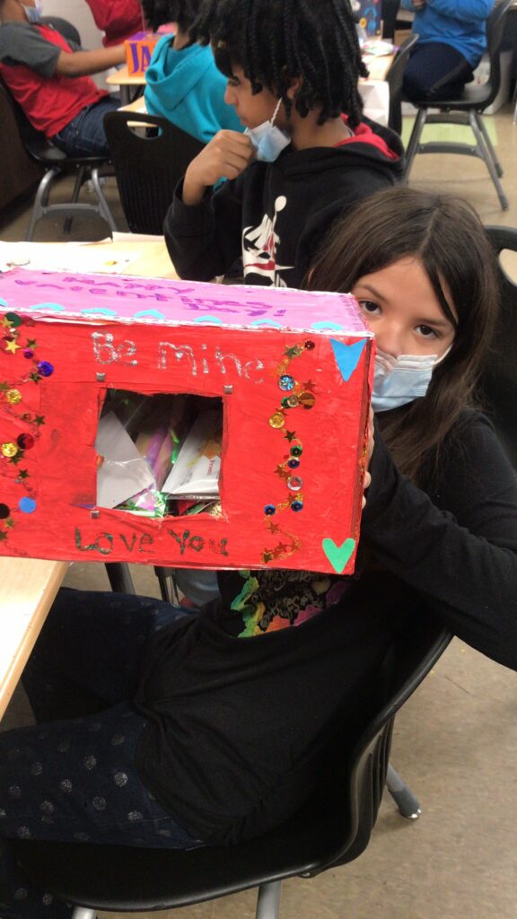 A student shows her creative valentine box.