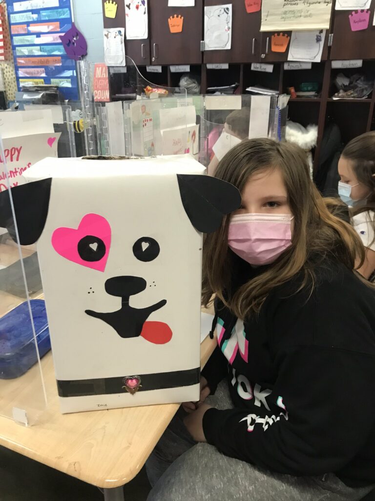 A student and her puppy themed valentine box.