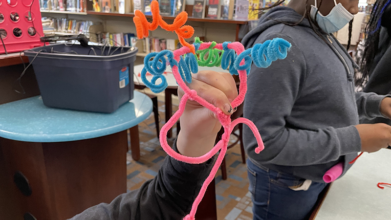 A pipe cleaner art project completed by a student.