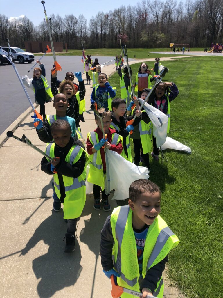 Students use their grabbers to help clean up our school grounds.