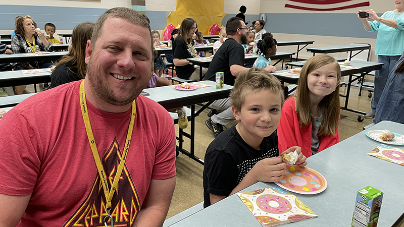 Second graders enjoy their donut award with Mr. Irwin,