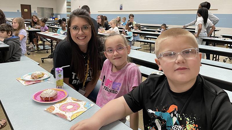 Second graders enjoy their donut award with Mrs. Laprocina.