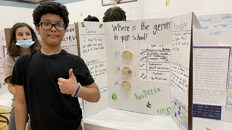 A student with their project about germs.