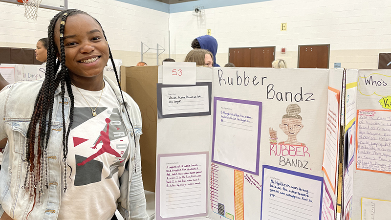 A student and their project about rubber bands.