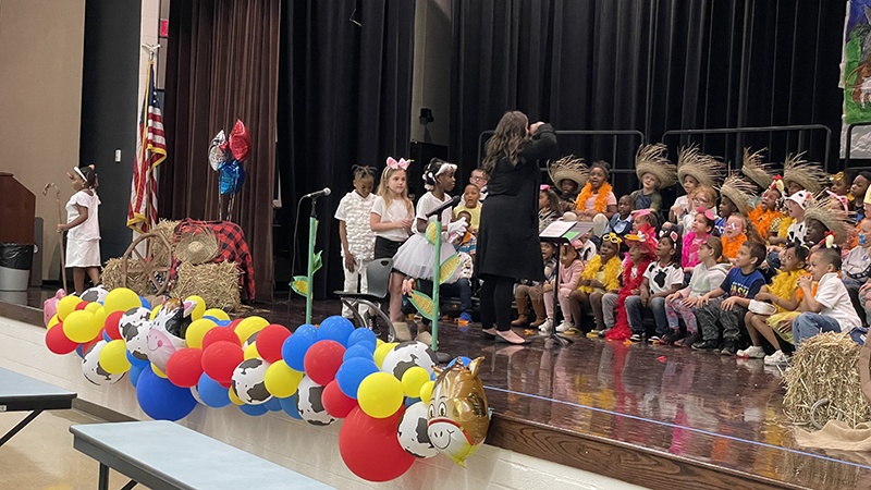 Ms. Komsa leading the musical.